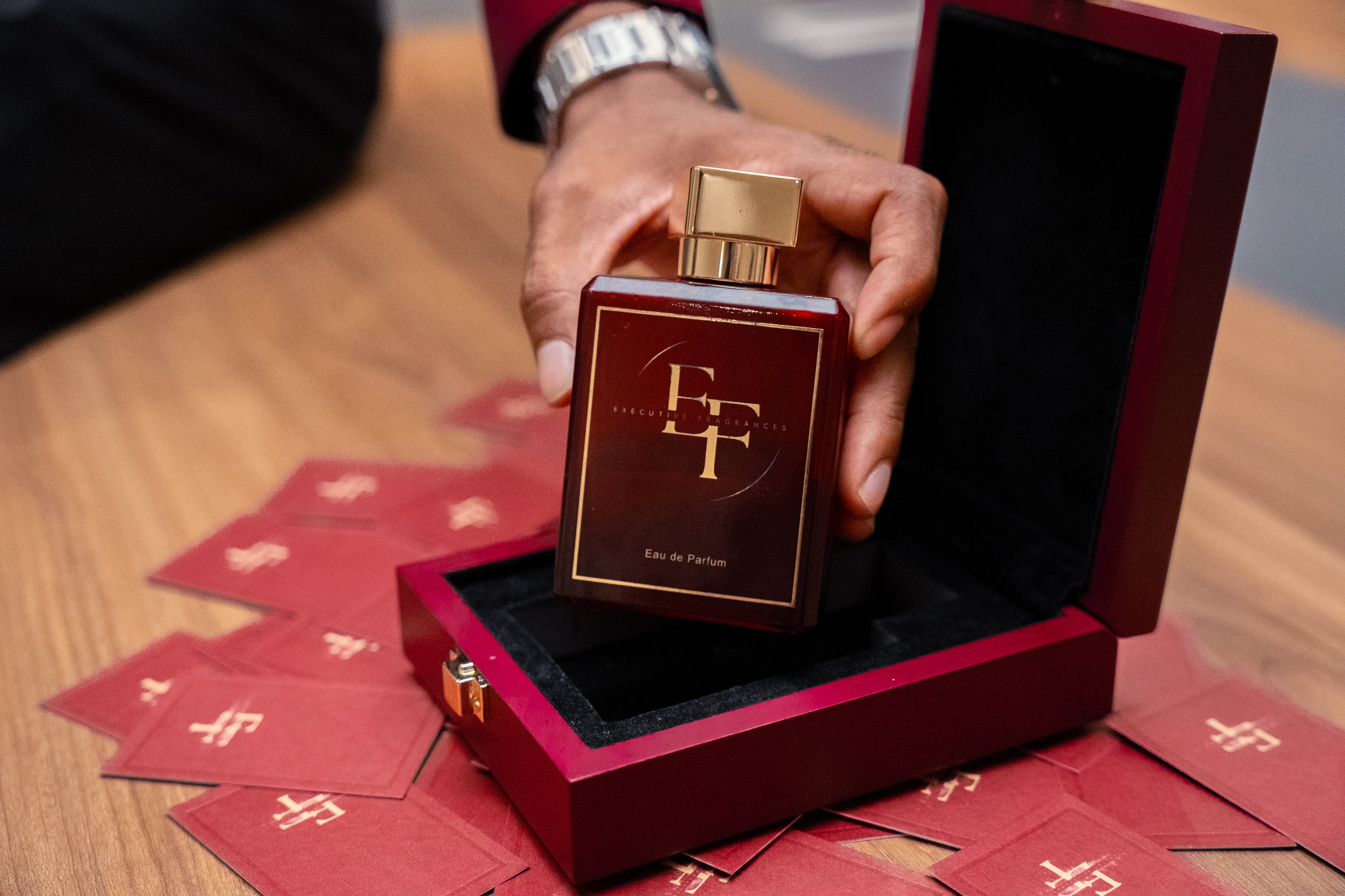 Executive Fragrances Pack shot with sample cards held in a male hand